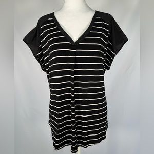 Adrienne Vittandi black tee with white stripe.